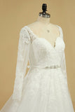 2024 A Line Long Sleeves Wedding Dresses Tulle With Applique And Sash Sweep PA3KBB8E